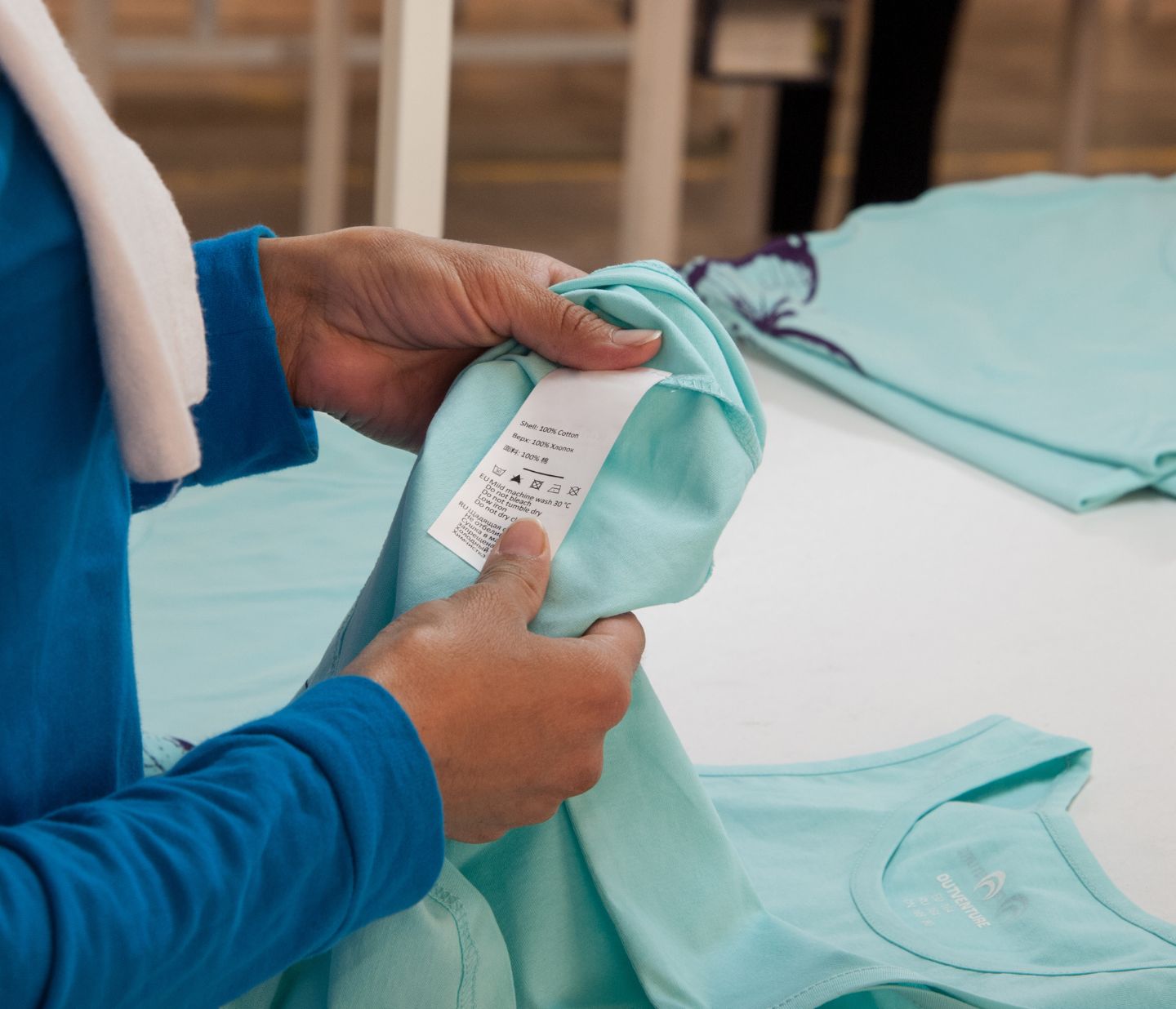 A person looking at clothing label